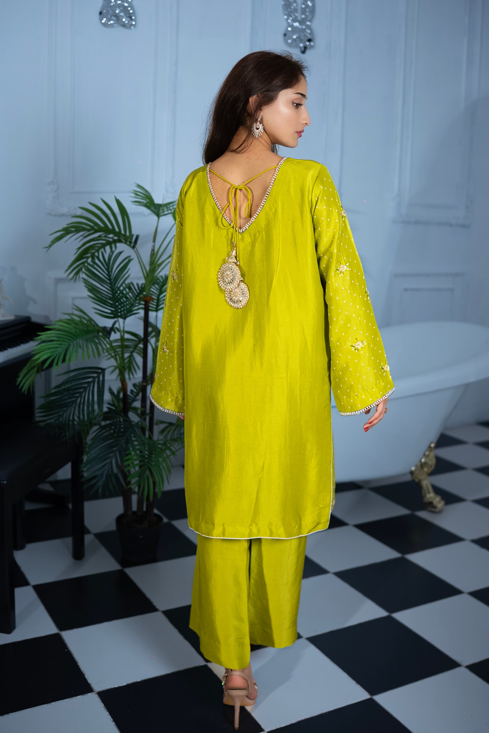 Back view of Citrus Sorbet Pakistani suit showing pearly tassel detailing and beaded neckline