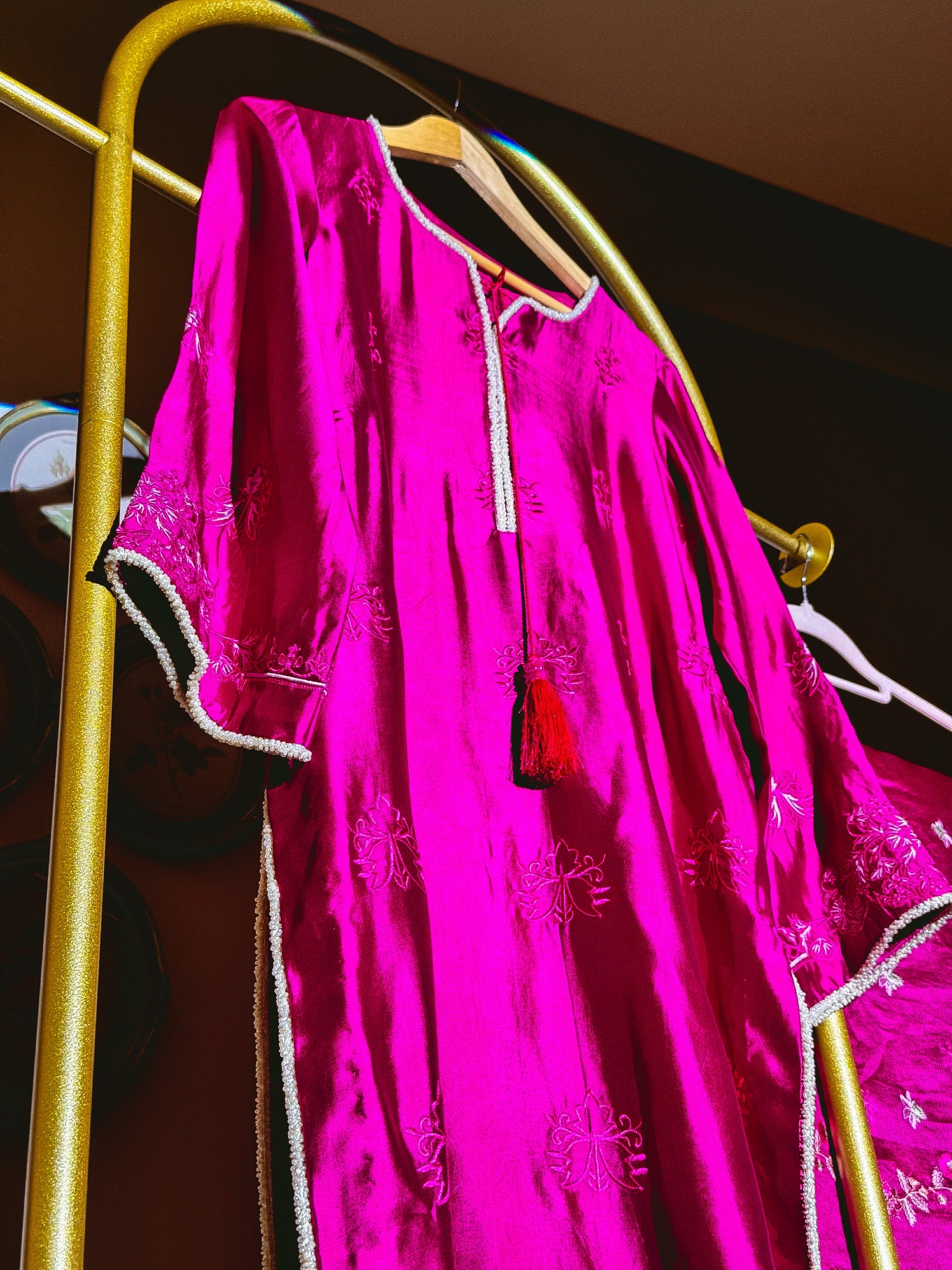Fuchsia Pakistani three-piece suit with floral embroidery and flowing dupatta