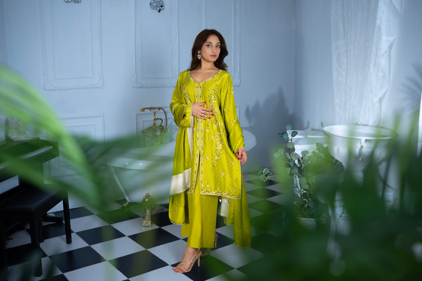 Woman wearing Citrus Sorbet raw silk Pakistani suit, luxury Pakistani wear in the UAE