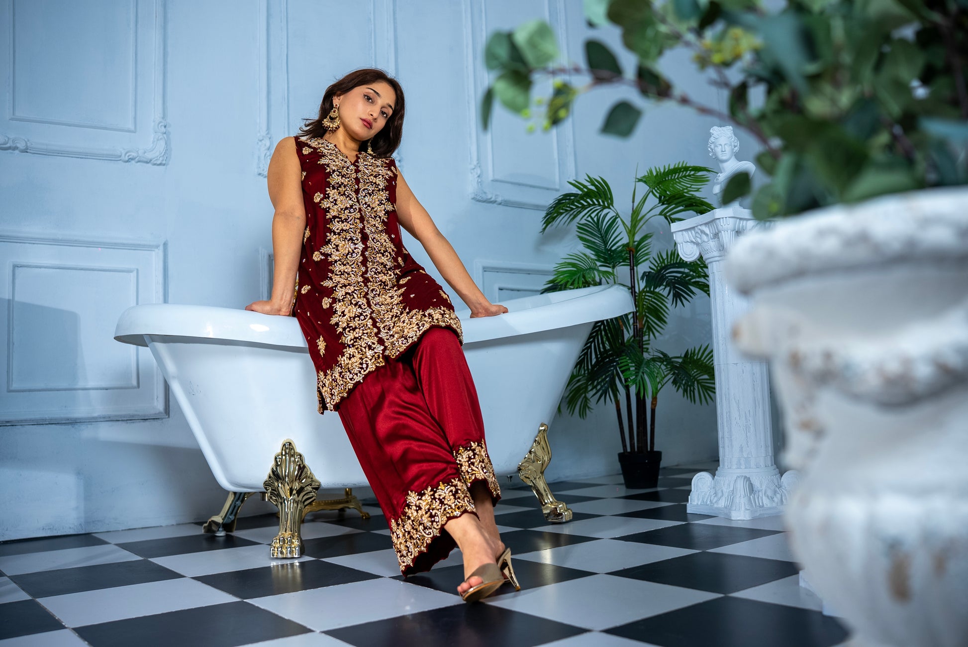 Close-up of Veloura maroon khaddi net suit gold embroidery detailing