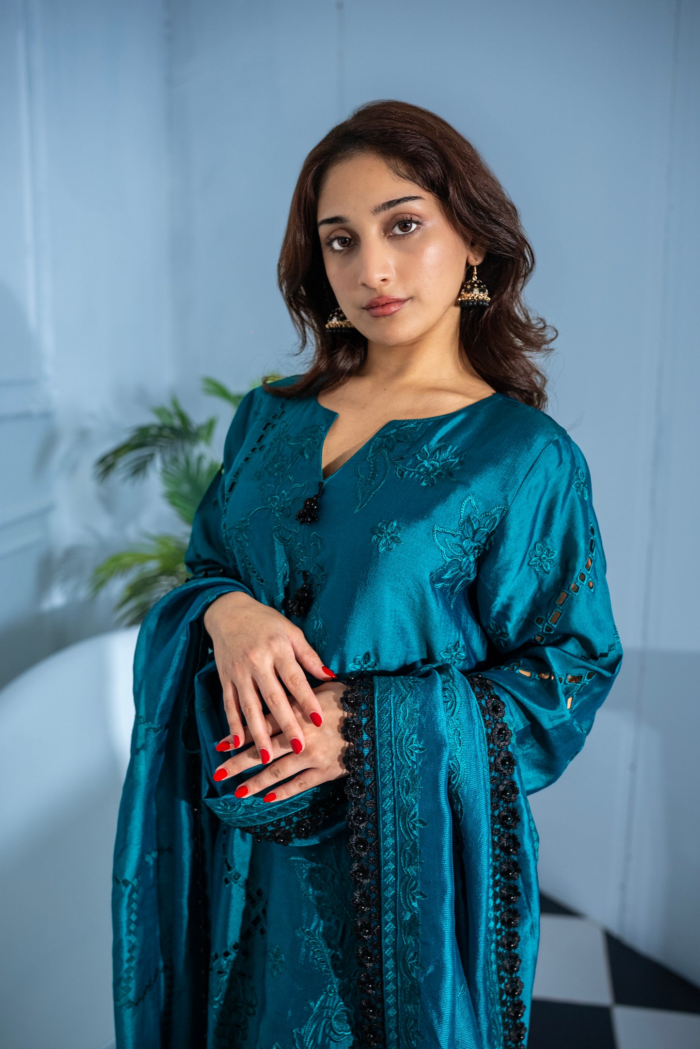 Woman wearing Verdant Grace dark green tissue silk suit, luxury Pakistani wear UAE