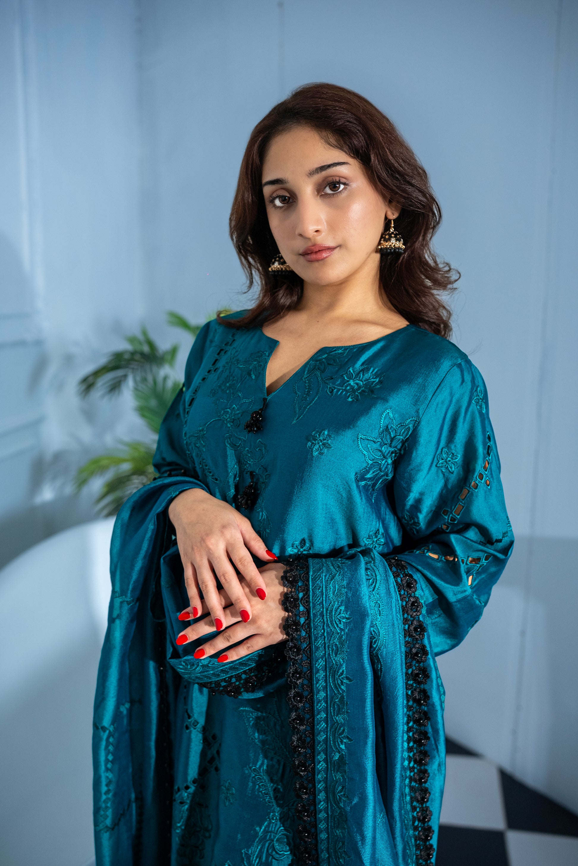 Woman wearing Verdant Grace dark green tissue silk suit, luxury Pakistani wear UAE