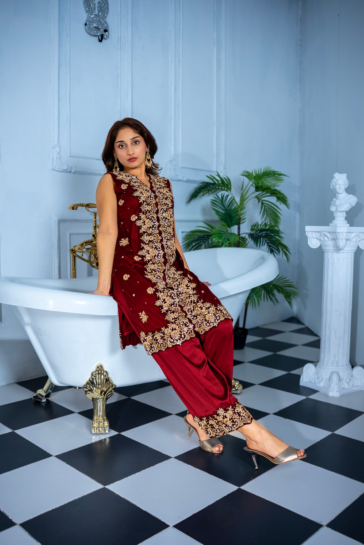 Veloura maroon khaddi net suit with intricate gold embroidery