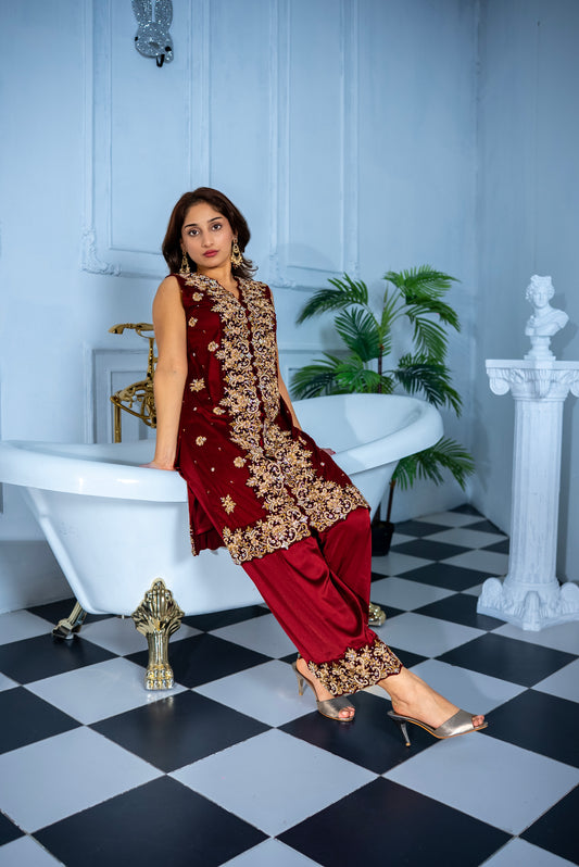 Veloura maroon khaddi net suit with intricate gold embroidery